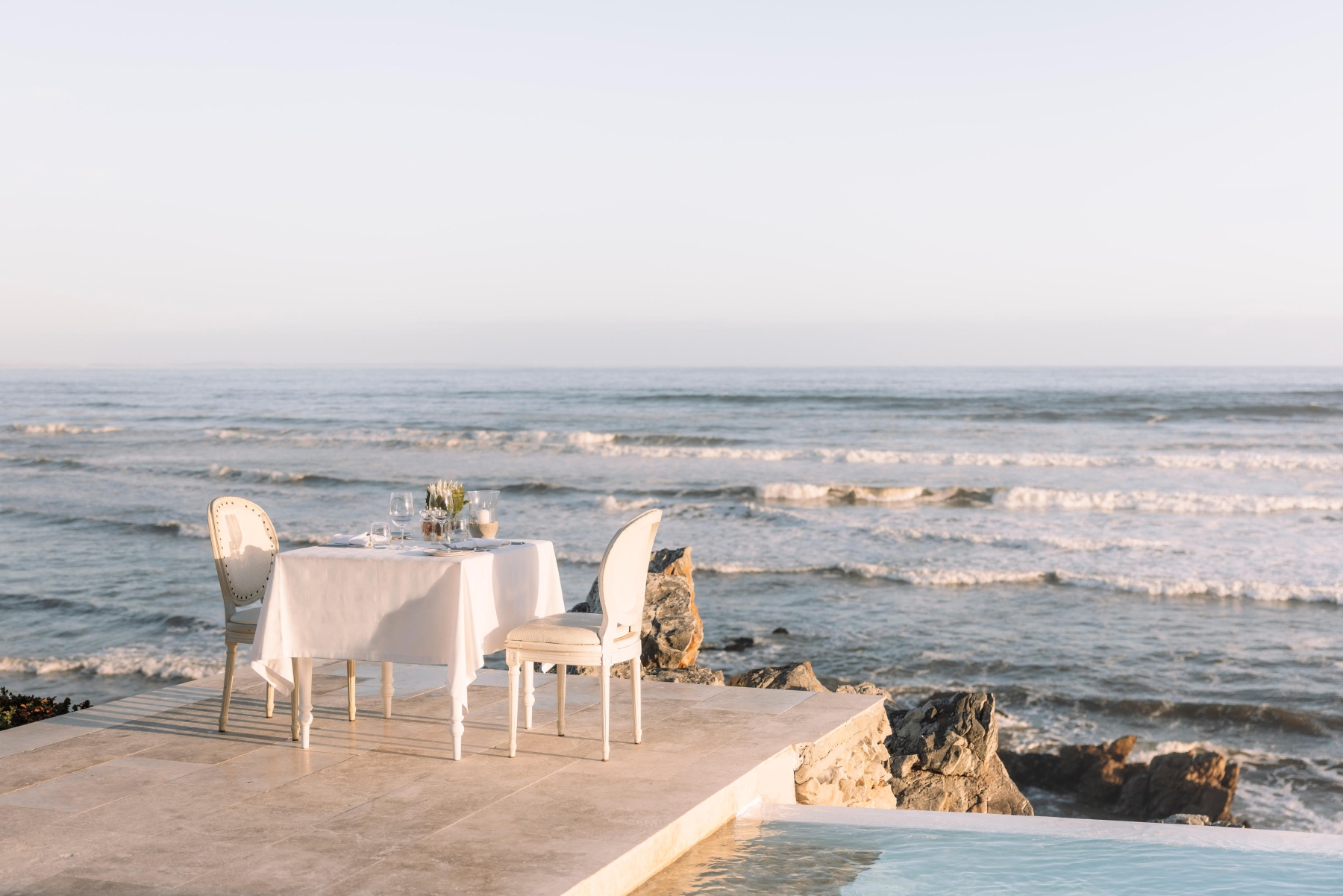 Birkenhead-house-outdoor-dining A private dining table set for two overlooks the ocean, offering a peaceful and romantic setting for a babymoon safari.